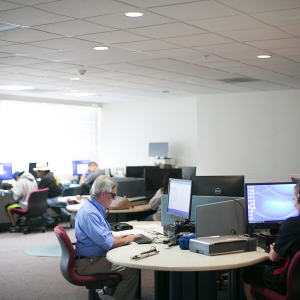 Two people use computers in Wayfinder's assistive technology training lab in Los Angeles