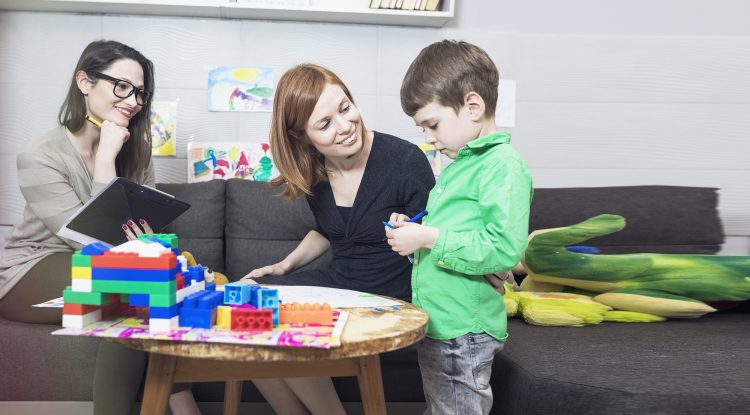 Mental health therapist works with a parent and child