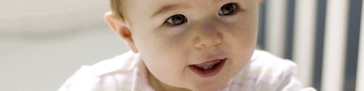 A baby in a crib smiling