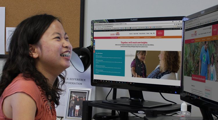 A teen works on her computer during her internship through Wayfinder's youth transition services