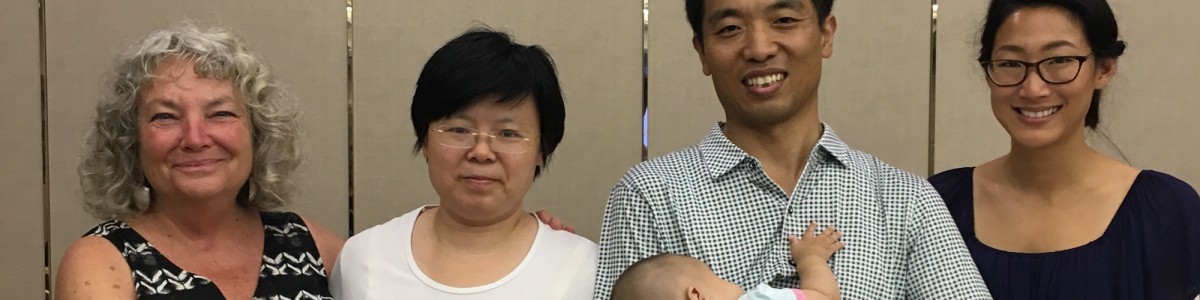 Wayfinder's Blind Babies Foundation vision impairment specialists Drue and Michelle stand next to parents of an infant at the Bethel China early intervention forum in Beijing