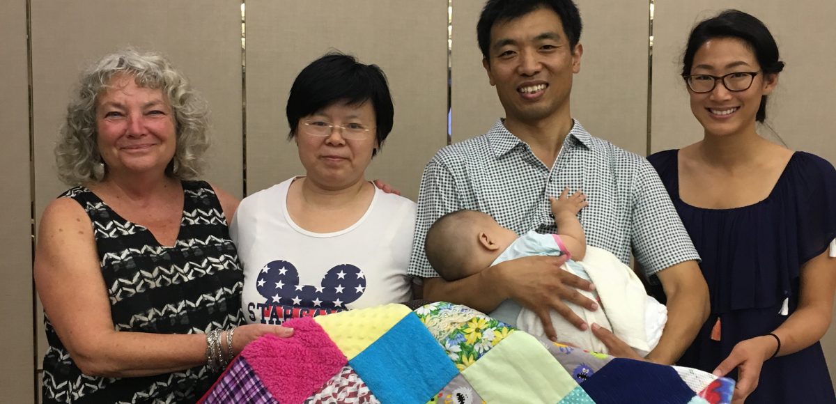 Wayfinder's Blind Babies Foundation vision impairment specialists Drue and Michelle stand next to parents of an infant at the Bethel China early intervention forum in Beijing