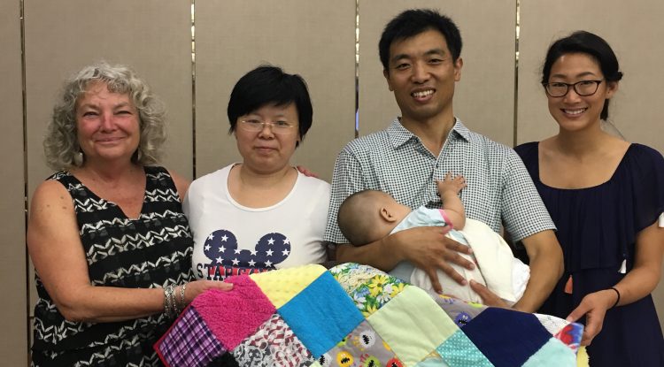 Wayfinder's Blind Babies Foundation vision impairment specialists Drue and Michelle stand next to parents of an infant at the Bethel China early intervention forum in Beijing