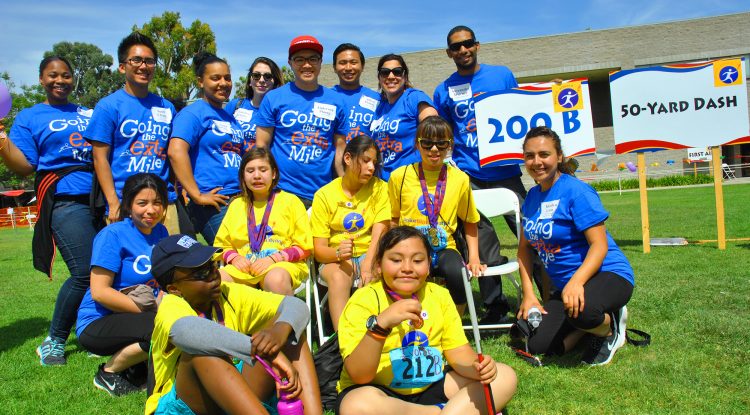 An employee group of volunteers smiles during a Wayfinder event