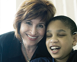 Current President and CEO Miki Jordan smiles with a student