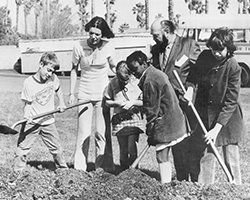 Nadia Kaplan and a few students from Junior Blind hold shovels as they dig into the ground during the opening of our current campus
