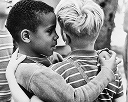 The iconic photograph of a young African American boy with his arm around a young Caucasian boy at Junior Blind's Camp Bloomfield