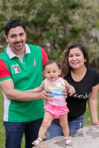 Hector, and Maria smile with their baby Elena