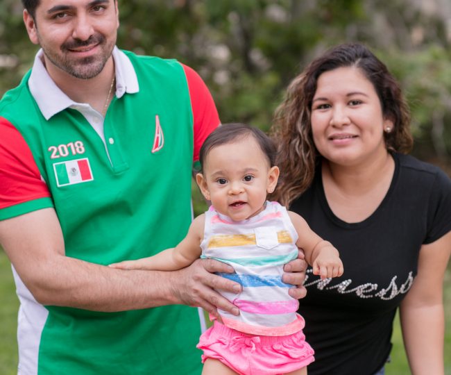 Hector, and Maria smile with their baby Elena