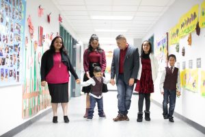 Isaias and his family in the special education school hallway