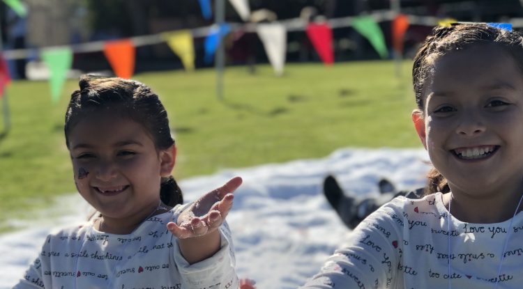 Two young girls playing in snow