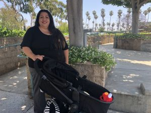 mom smiling and pushing stroller