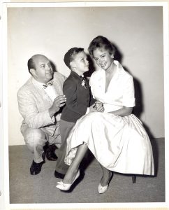 June Lockhart and our founder Norm Kaplan with a young boy who is visually impaired