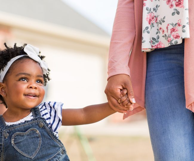 toddler holding adult's hand