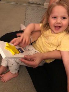 Harper sits with a three-dimensional star in her lap