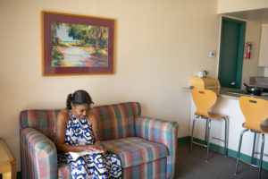 woman who is visually impaired sits on couch in apartment