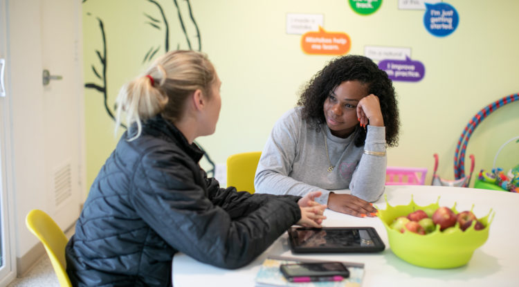 counselor sitting at table with youth