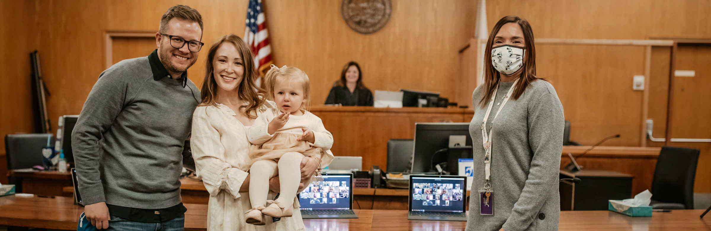 parents child and social worker stand in front of judge