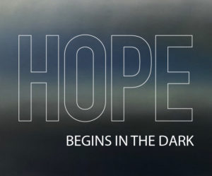 picture of caption that reads, Hope Begins In The Dark