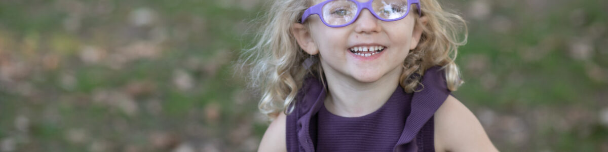 Toddler wearing glasses smiling