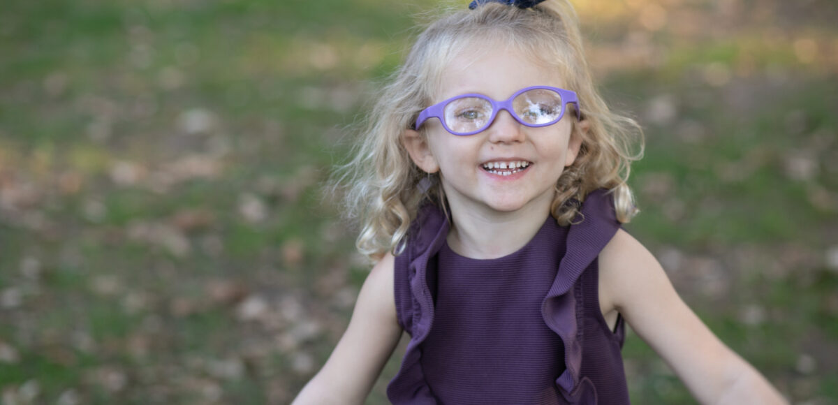 Toddler wearing glasses smiling