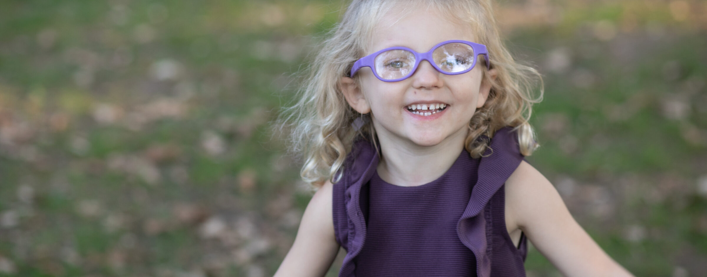 Toddler wearing glasses smiling