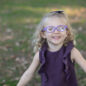 Toddler wearing glasses smiling