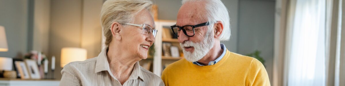 older man and woman smiling at each other