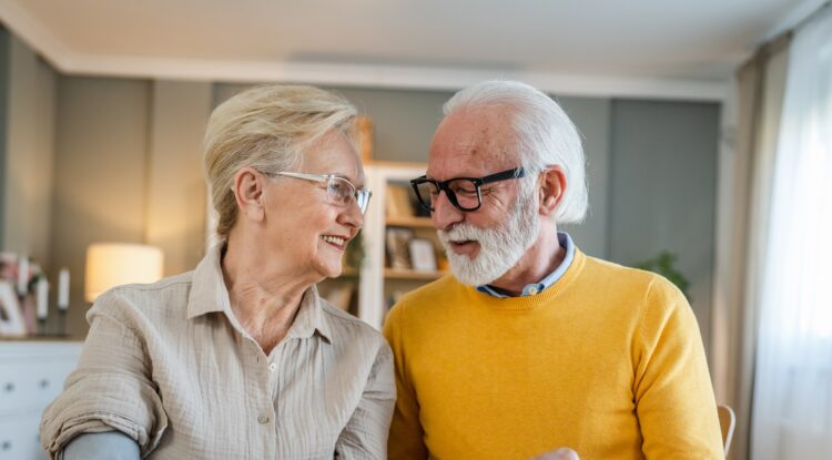 older man and woman smiling at each other